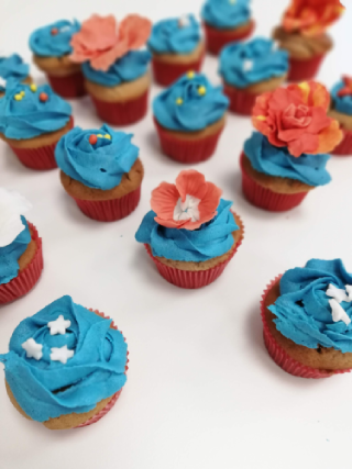 marble cake birthday cupcakes with homemade buttercream frosting and gumpaste flower garnishes
