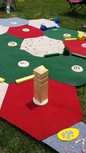 giant lawn version of Settlers of Catan made with carpet squares and wooden pieces